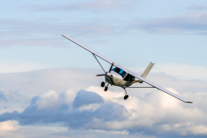 Photo of an airplane flying at Springbank Airport